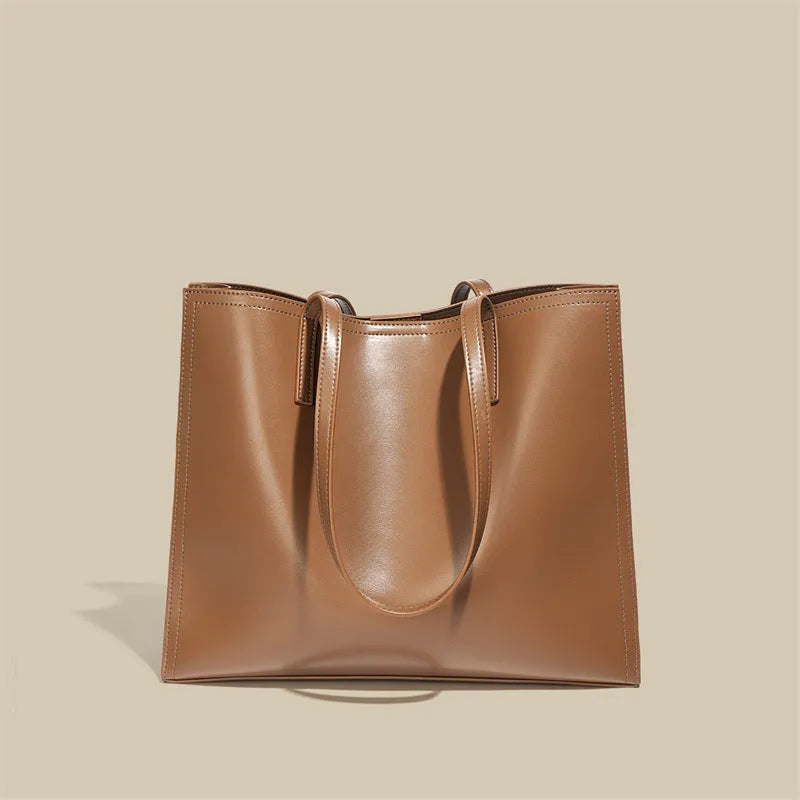 Brown genuine leather one shoulder handbag showing horizontal square shape and single strap.
