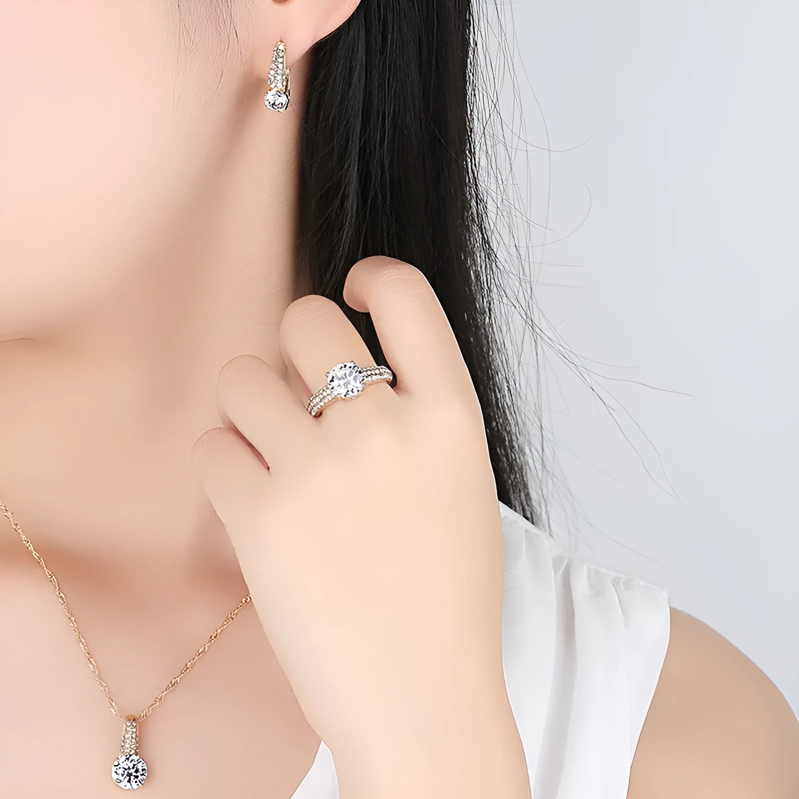 Gold and silver bridal necklace and earring set with copper base platinum finish on display