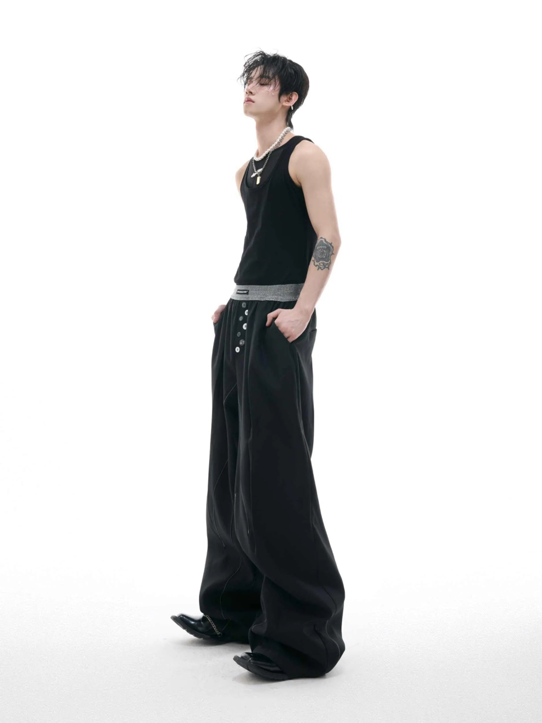 A pair of high-waisted straight-leg casual trousers in grey with a button fly front.