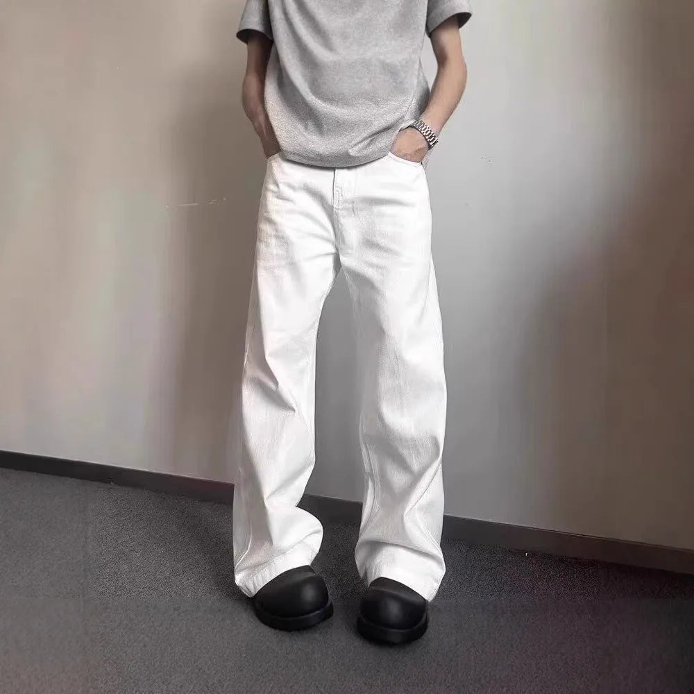 Men's straight leg white denim jeans with a mid waist and wide leg opening.