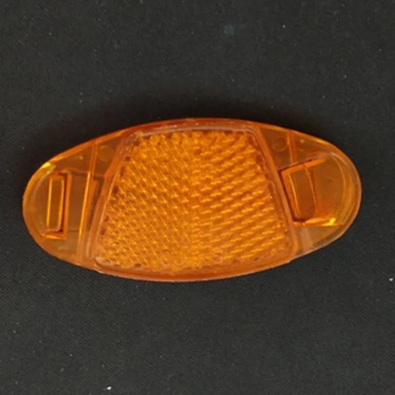 White and yellow plastic bicycle spoke reflector decorations showing front and rear placement on wheel spokes