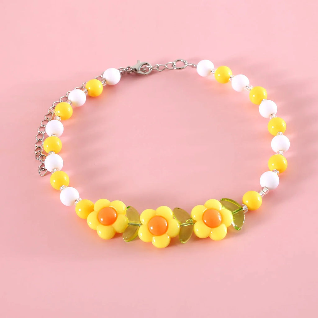 Colourful plastic bead cat necklace showing small flower, rainbow, and peach pattern options with adjustable sizing