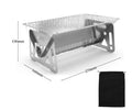Large foldable stainless steel barbecue oven with storage bag, set up for outdoor use.