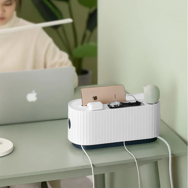 Blue and white power strip storage box with lid open showing cable holes and phone slot.