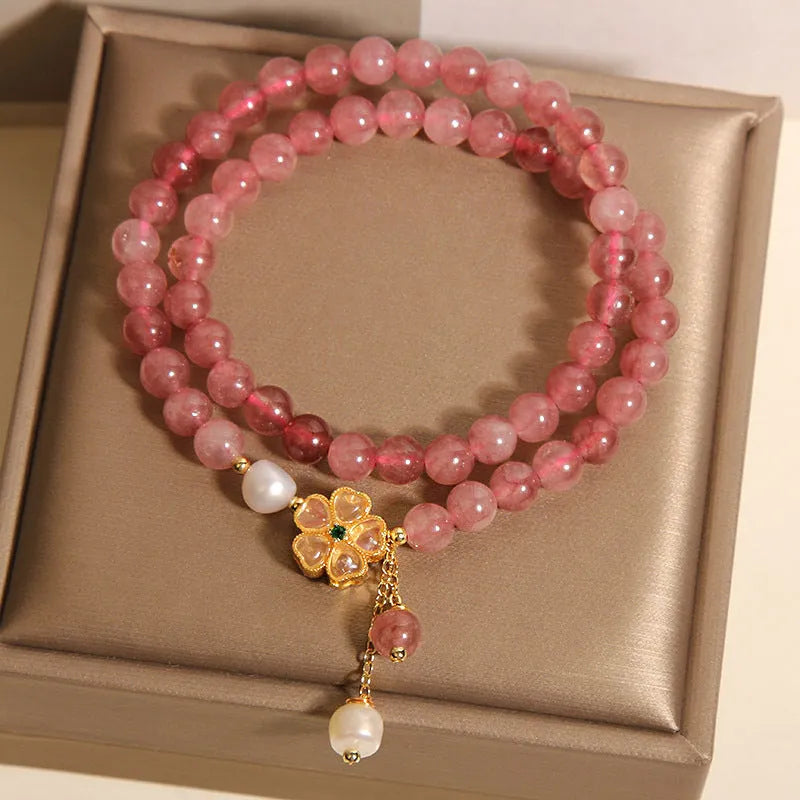 Women's double ring bracelet with a strawberry quartz twin four-leaf clover design.