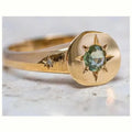 Gold-colour adjustable ring with an oval-shaped star design and central zircon stone.