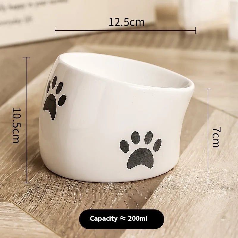 Ceramic cat bowl with high foot design and oblique mouth in cat's paw pattern