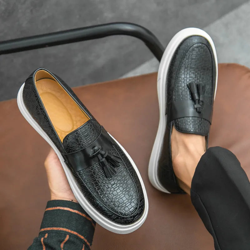 Men's black casual leather shoes with fringe detail on round toe, low heel.
