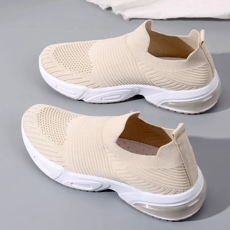 Slip-on breathable sock shoes in black, pink, khaki, and white colours on a white background.