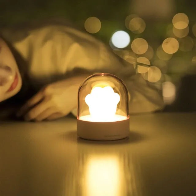 Grey cat paw USB charging music box night light with adjustable brightness on wooden desk