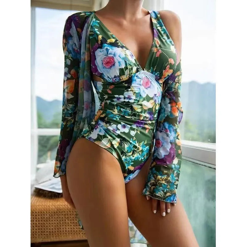 Women's floral patterned tight bikini three-piece swimsuit set with a coat on a hanger.