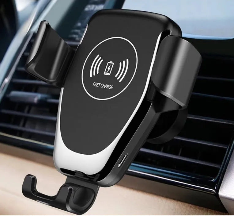 Black car wireless charger mounted on vent, holding iPhone with automatic support arms visible