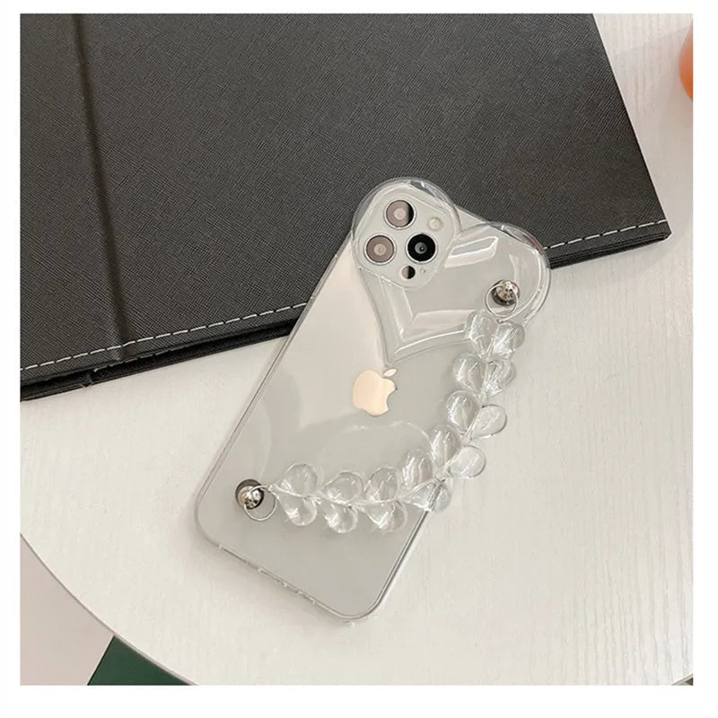 Transparent iPhone case with an attached clear love heart charm bracelet on a TPU shell.