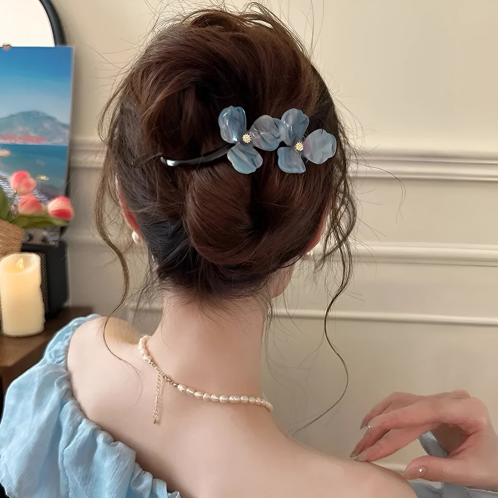 Retro flower petal bobby pin hair accessory in acrylic, shown on a background.