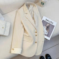 Milky white loose-fit mid-length women's coat with long sleeves and pockets on a hanger.