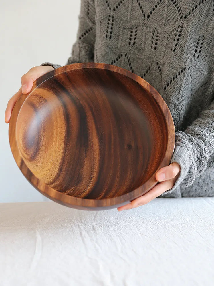 Natural brown wooden bowl with wood grain, overglaze finish, 12x6cm, on a table