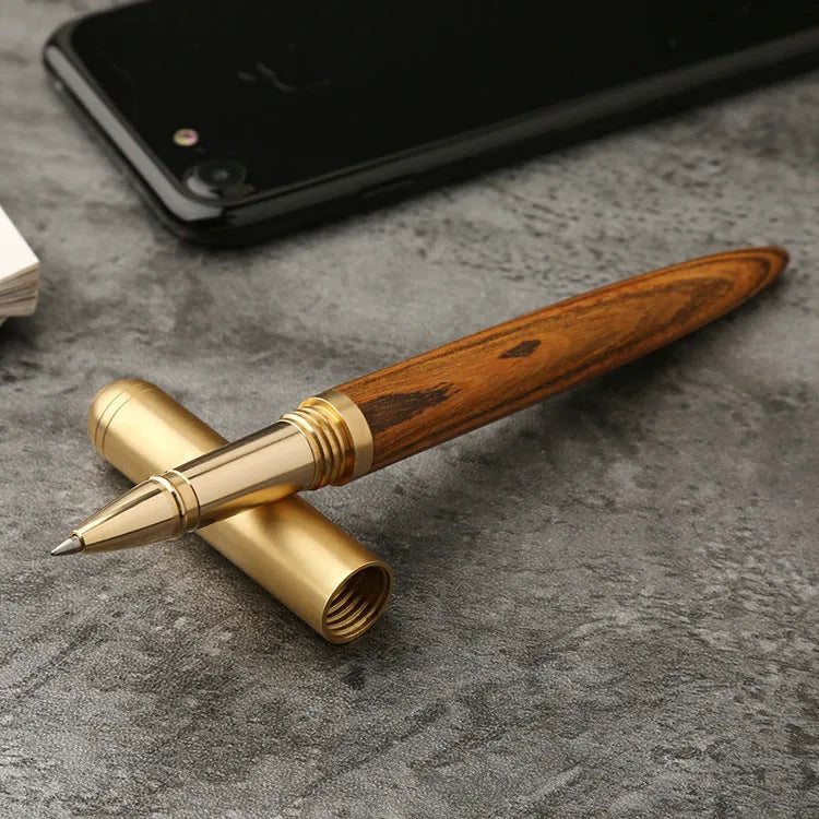 Solid wood and brass signature pen showing choice of ebony, rosewood, sandalwood, tiger skin wood, and wingwood finishes.