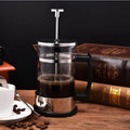 Compact 350ml capacity coffee maker made of glass and stainless steel.