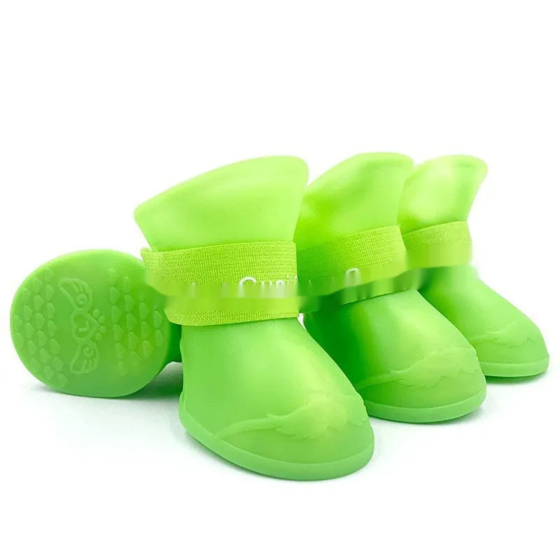 Set of four anti-slip pet rain shoes in various colours with rubber soles for waterproof dog paw protection.
