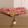 Women's double ring bracelet with a strawberry quartz twin four-leaf clover design.