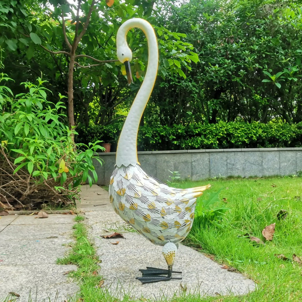 Wrought iron swan solar garden light with warm white LED on a lawn