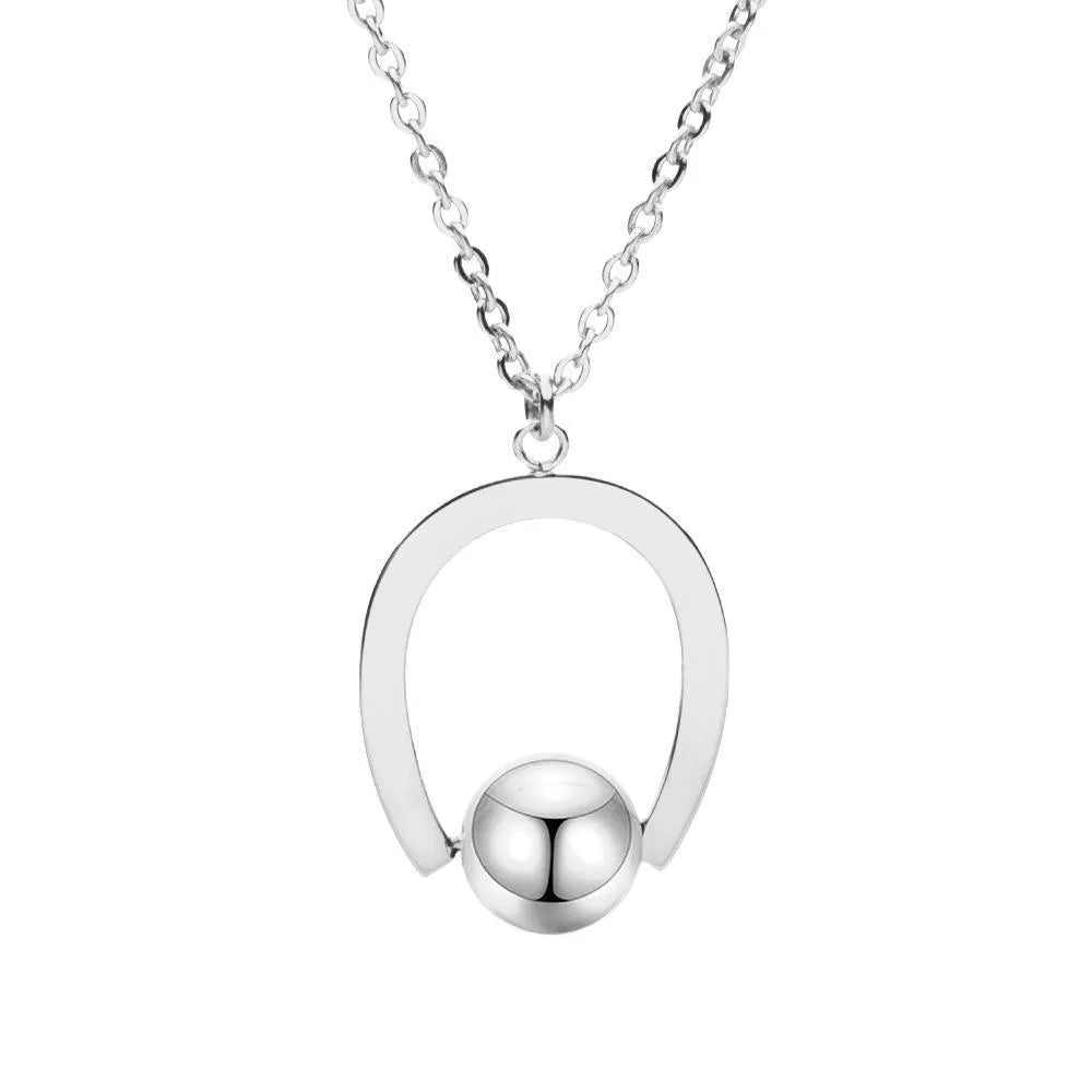 Gold electroplated stainless steel necklace with geometric pendant on an adjustable chain.