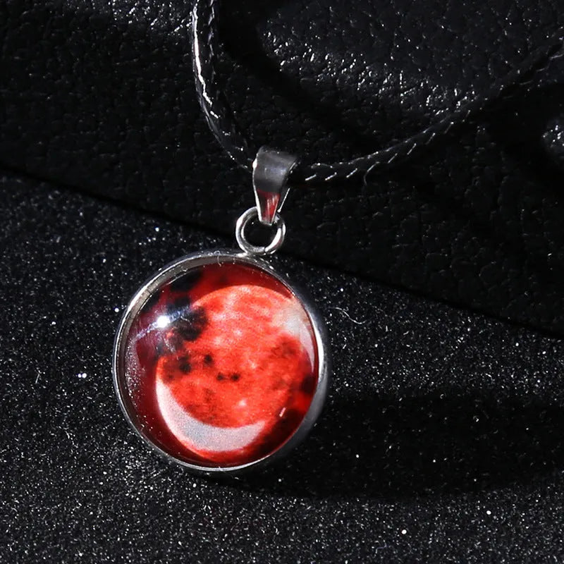 Luminous moon and constellation glass pendant on a silver alloy necklace chain with an extension piece.