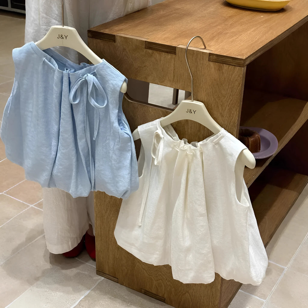 Milky white Korean style cotton drawstring shirt for girls with sleeveless design on light background
