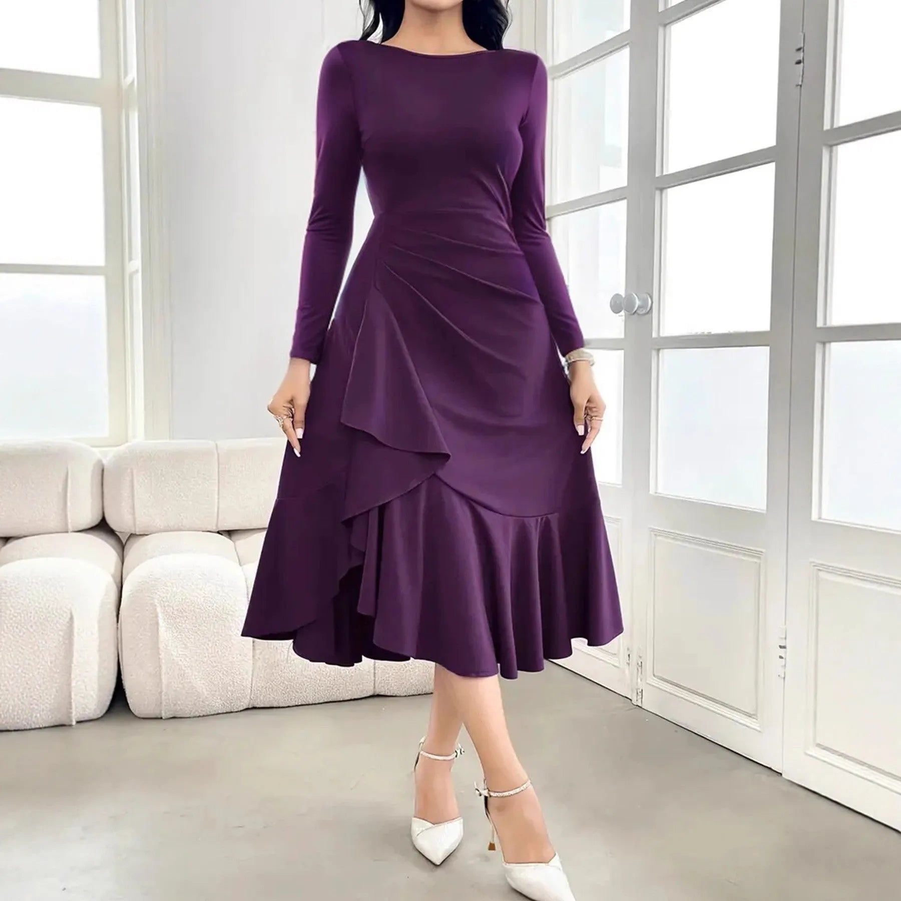 Purple women's long sleeve dress with round neck and ruffle detail on a hanger