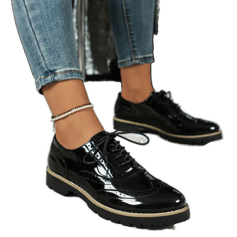 Women's black lace-up loafers with wedge heel, round toe, and sequin detail on the upper.
