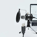 Black condenser microphone mounted on a silver aluminium adjustable stand with 3.5mm and USB cables.