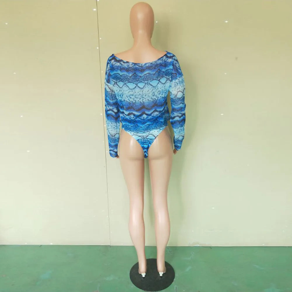 Women's purple snakeskin print bikini set with floral pattern and long sleeves.