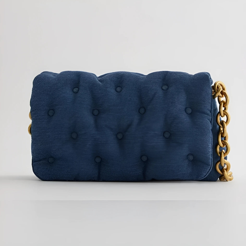 Blue oversized denim quilted shoulder bag with thick chain strap and padded buttons