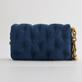 Blue oversized denim quilted shoulder bag with thick chain strap and padded buttons