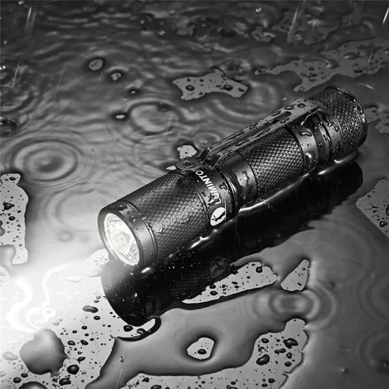 Lumintop Tool AA 2.0 black aluminium torch with keychain, shown next to included 14500 battery and diffuser.