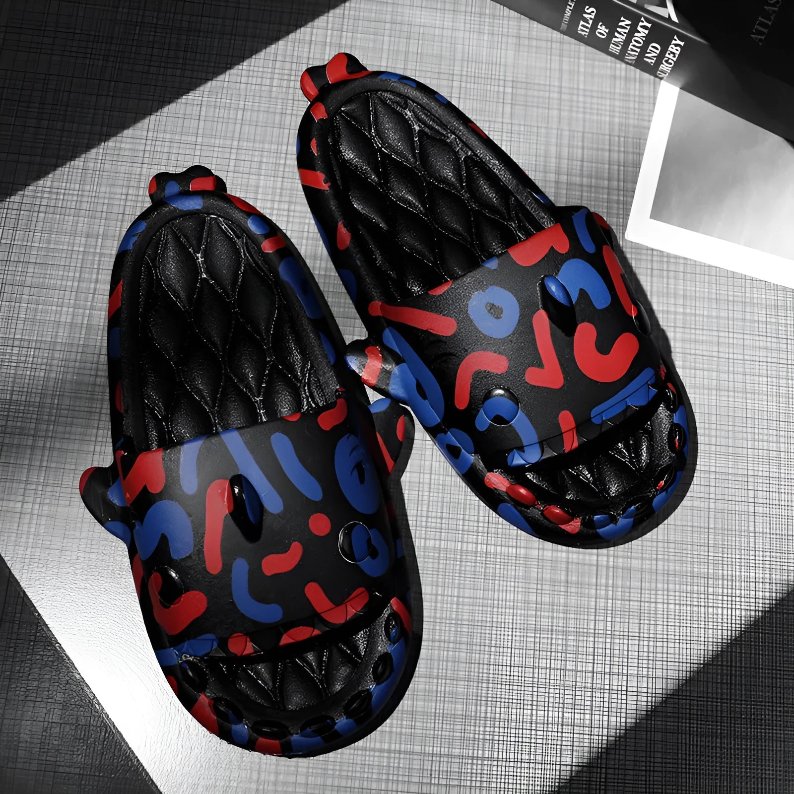 Pair of grey EVA open-toe slippers featuring a large raised shark design on the upper.