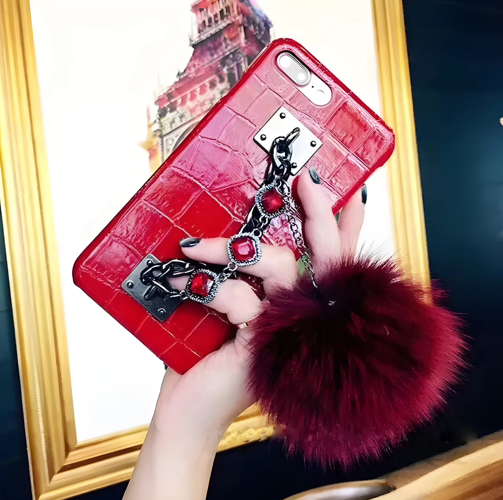 Red iPhone case with rhinestone decoration and attached fox fur ball showing Japanese Korean style design