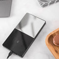 2-in-1 heated mug cup warmer and wireless charger on a desk with a coffee mug and smartphone