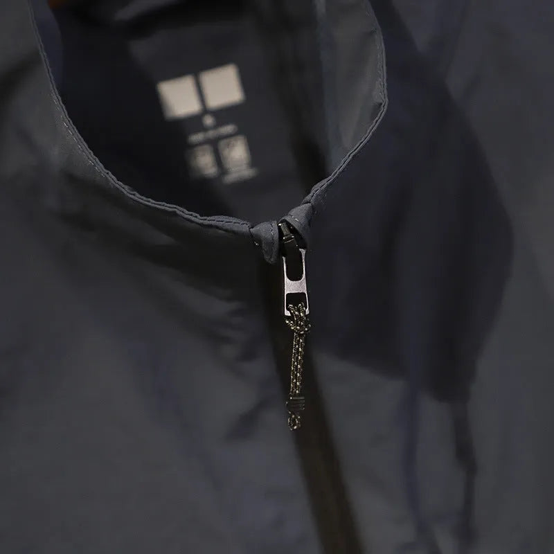 Men's solid colour nylon vest with side pockets in a straight, cardigan-style cut.