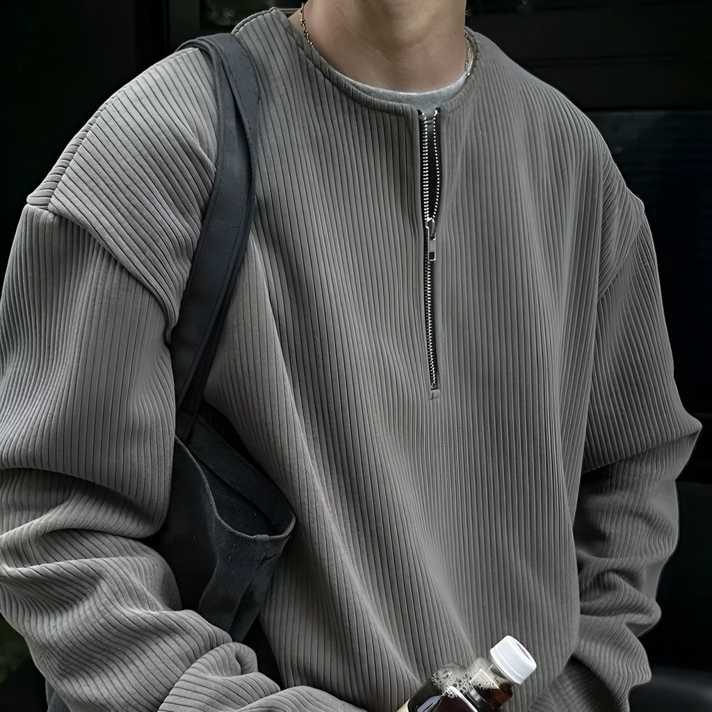 A woman's solid grey long sleeve loose fit pullover top on a hanger.