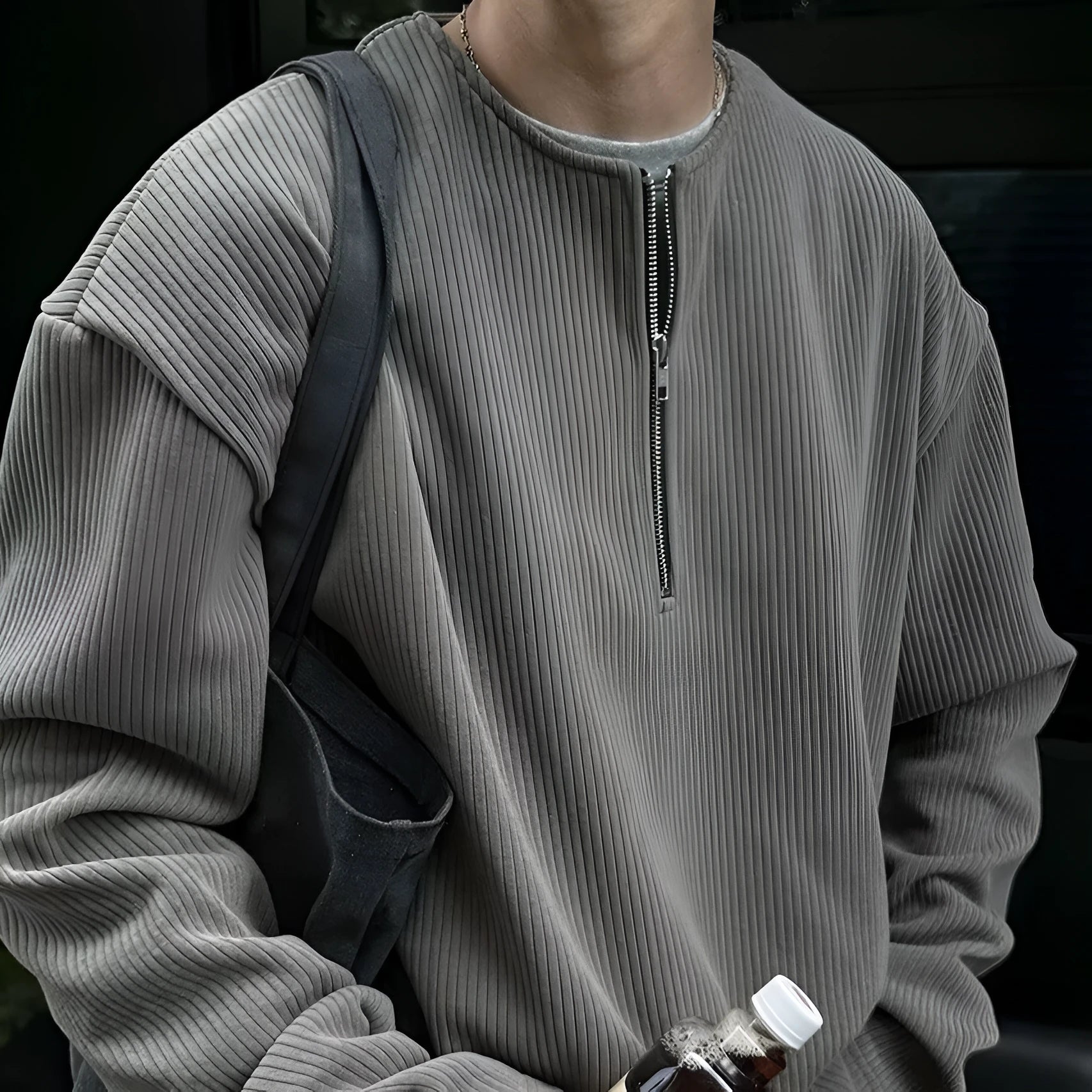 A woman's solid grey long sleeve loose fit pullover top on a hanger.