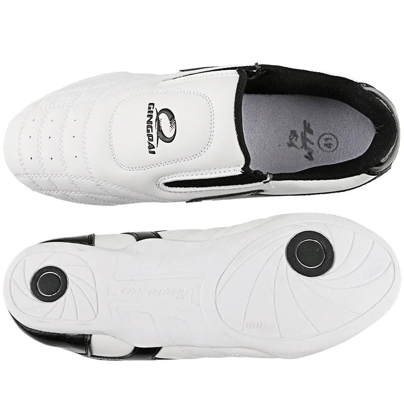 Black and white children's Sanda Taekwondo martial arts shoes with a soft sole and widened fit.