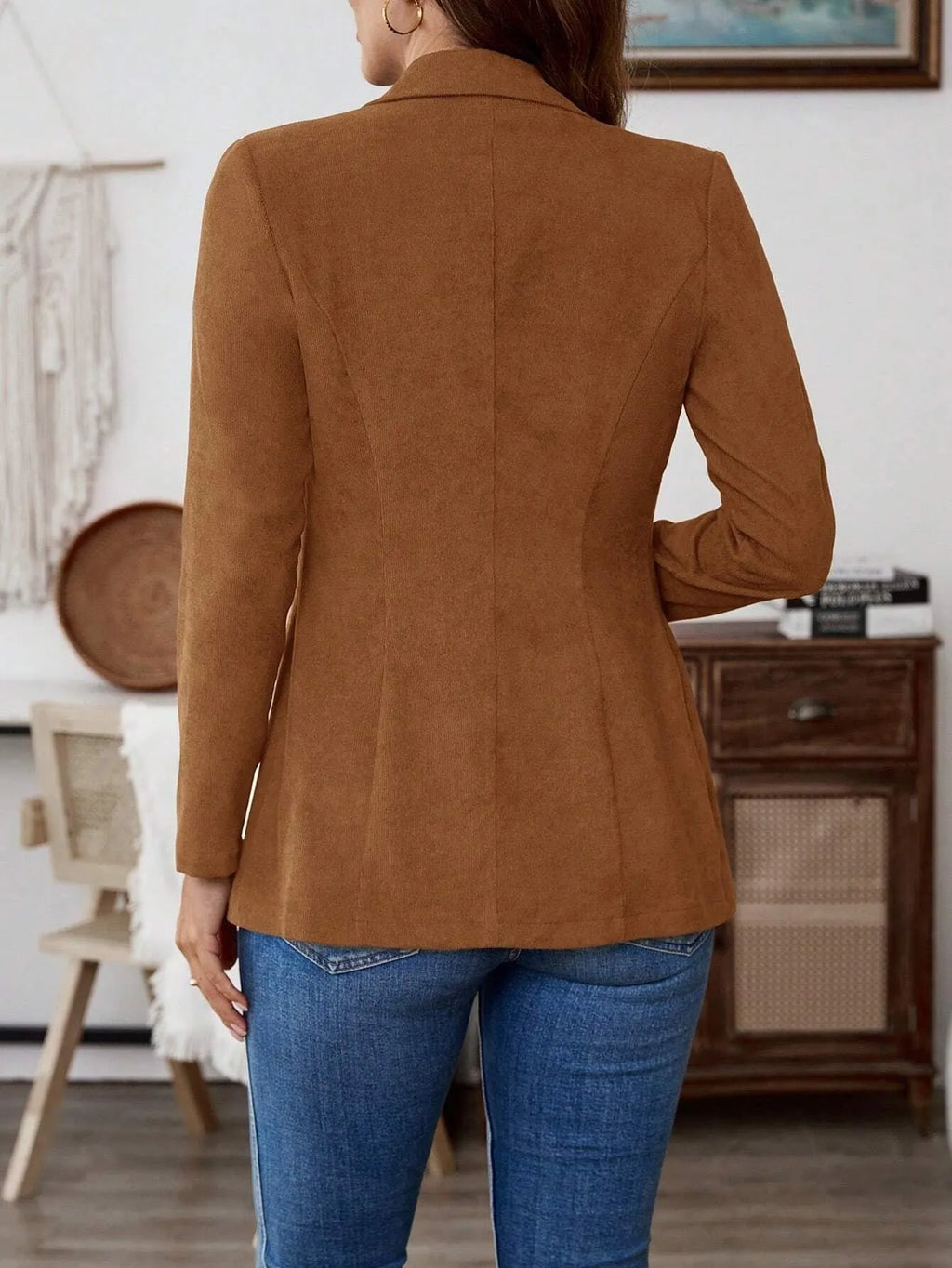 Brown men's single-breasted lapel suit coat on a hanger.