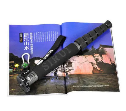 Black carbon fibre six-section SLR camera monopod extended to full height.