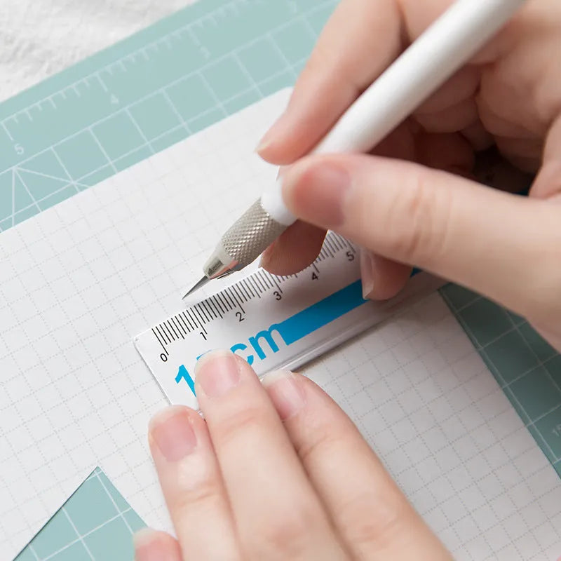 Art pen knife cutting board set in chosen colour with backing board, ruler, pen sharpener, and blade.