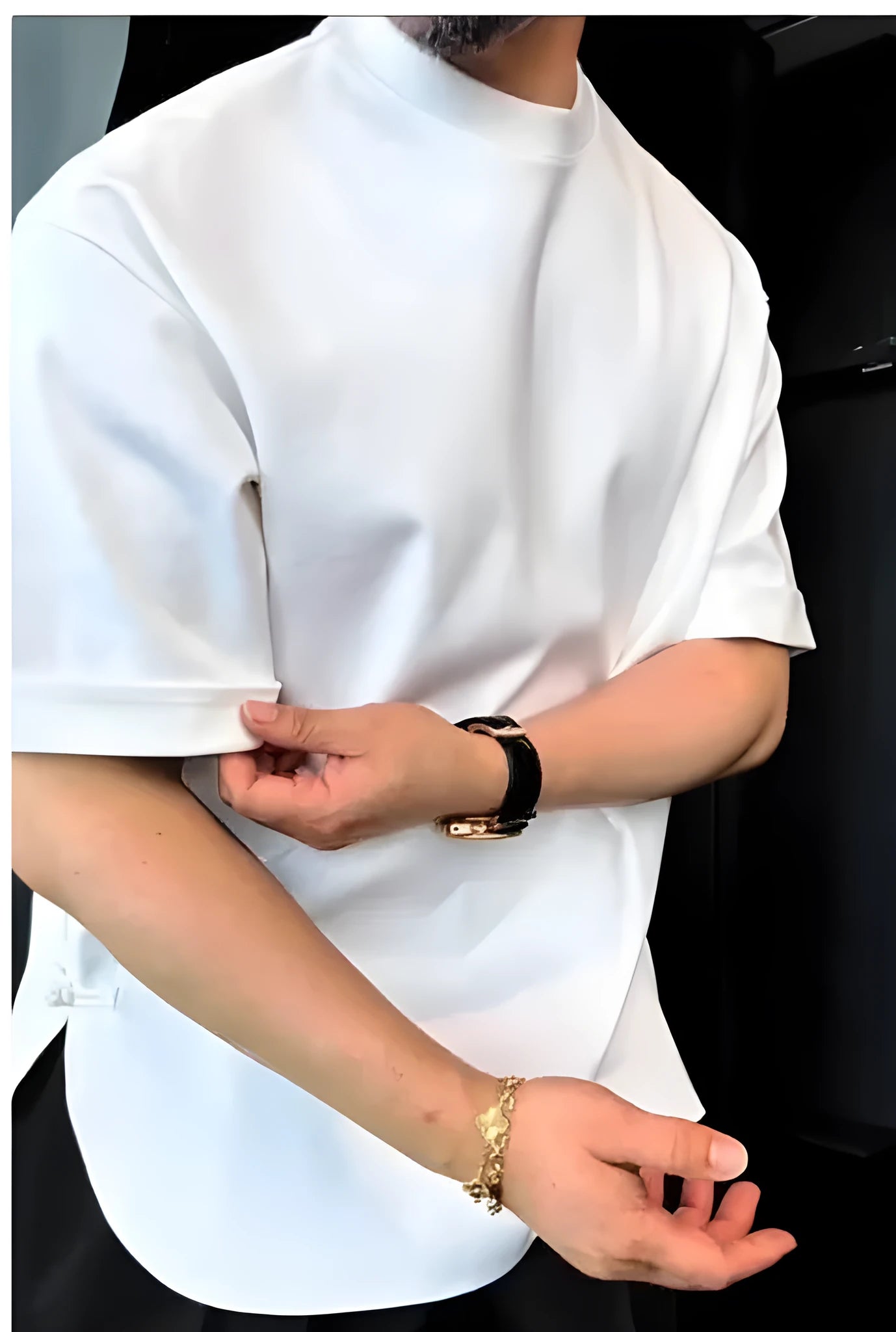 White men's buttoned t-shirt with long sleeves and a round hem laid flat.