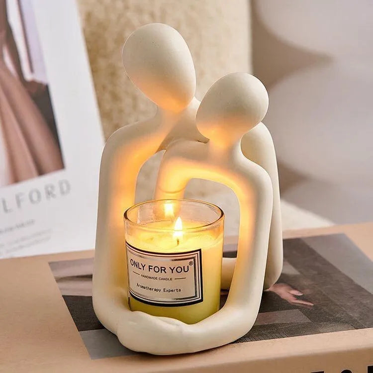 Modern milky white resin statue of a loving couple, a decorative accent for a desk or shelf.