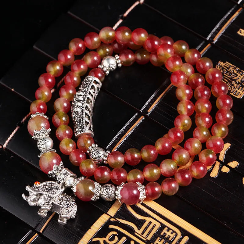 Watermelon crystal bracelet with Chinese knot design showing elephant style beads in geometric shape