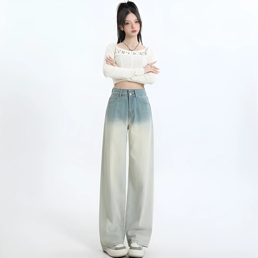 A pair of women's gradient blue wide-leg denim trousers on a neutral background.
