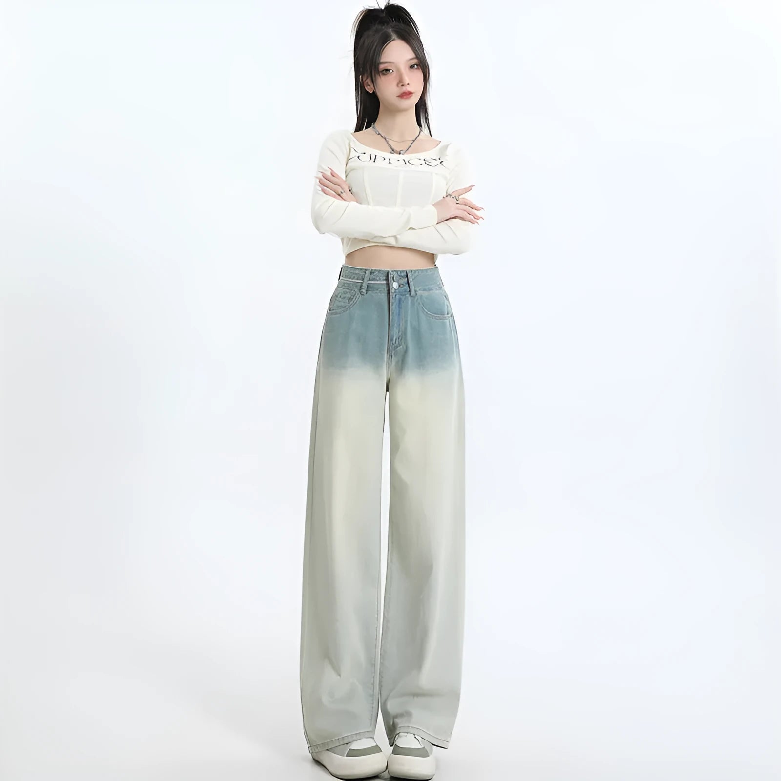 A pair of women's gradient blue wide-leg denim trousers on a neutral background.
